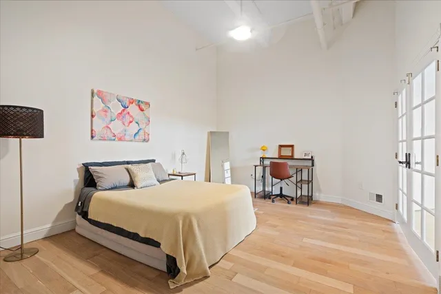 a spacious bedroom with a bed and a table