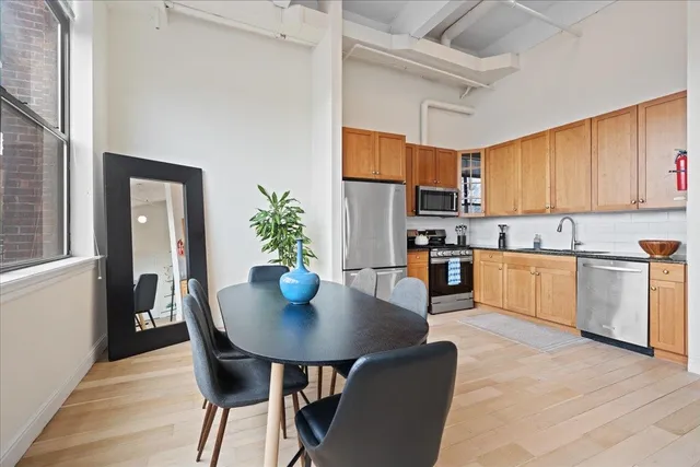 a dining room with furniture window and wooden floor