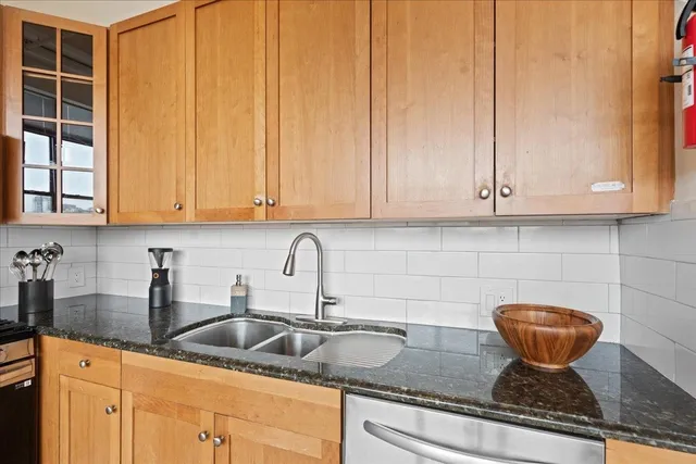 a kitchen with stainless steel appliances granite countertop a stove and a microwave