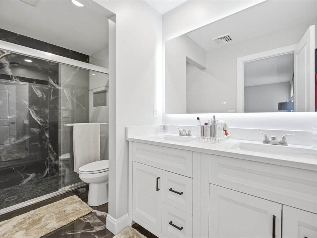 4 Wilshire Lane Pelham, NH 03076 - Photo 20 of 42 a bathroom with a sink toilet a mirror and shower