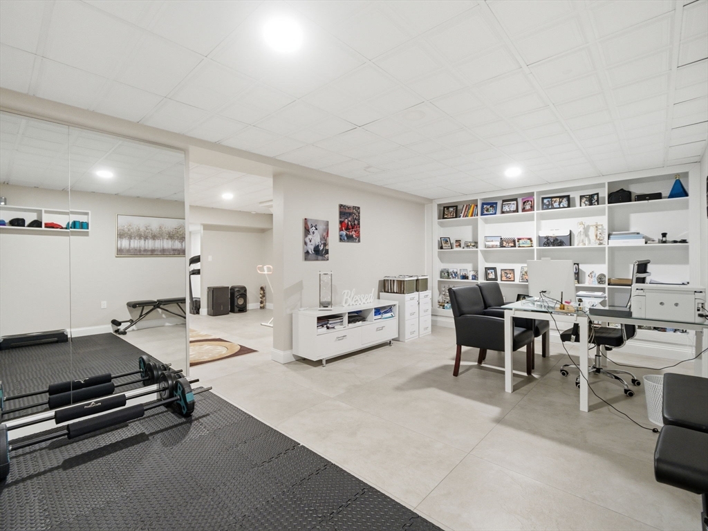 4 Wilshire Lane Pelham, NH 03076 - Photo 28 of 42 a living room with lots of furniture and clutter
