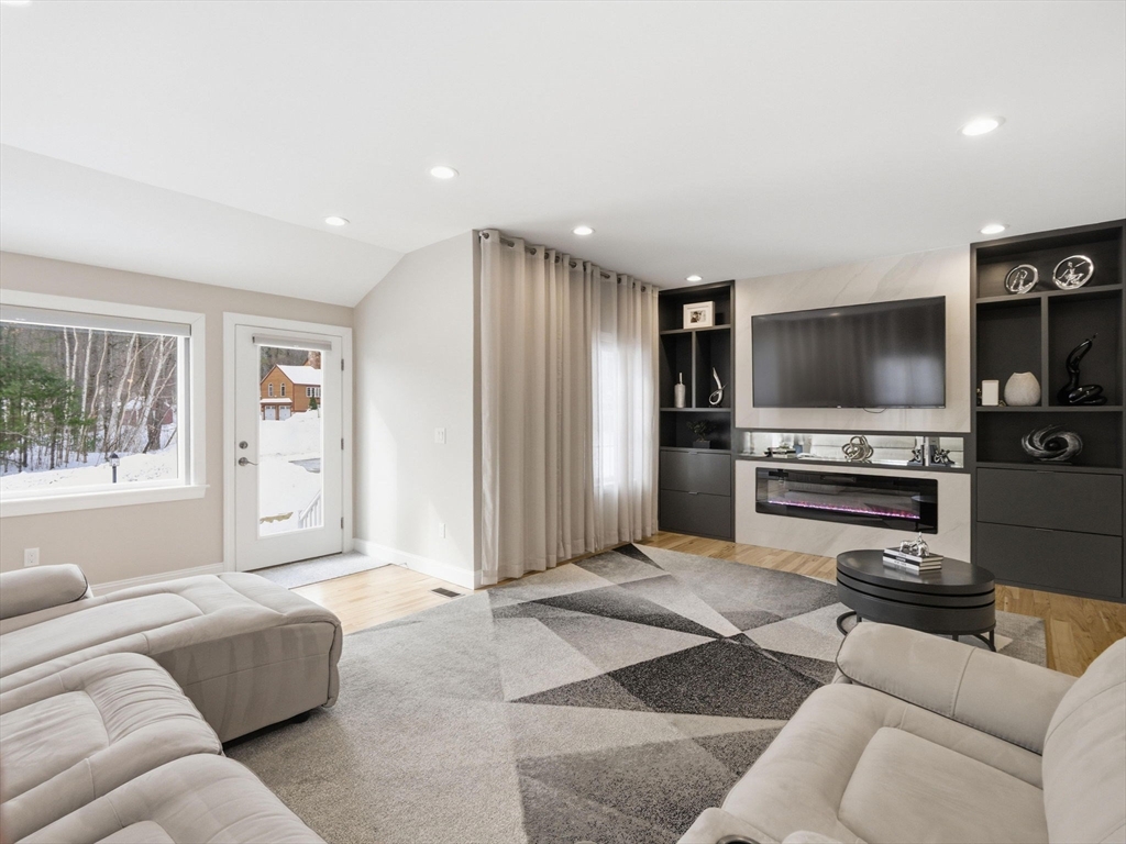 4 Wilshire Lane Pelham, NH 03076 - Photo 4 of 42 a living room with furniture and a flat screen tv