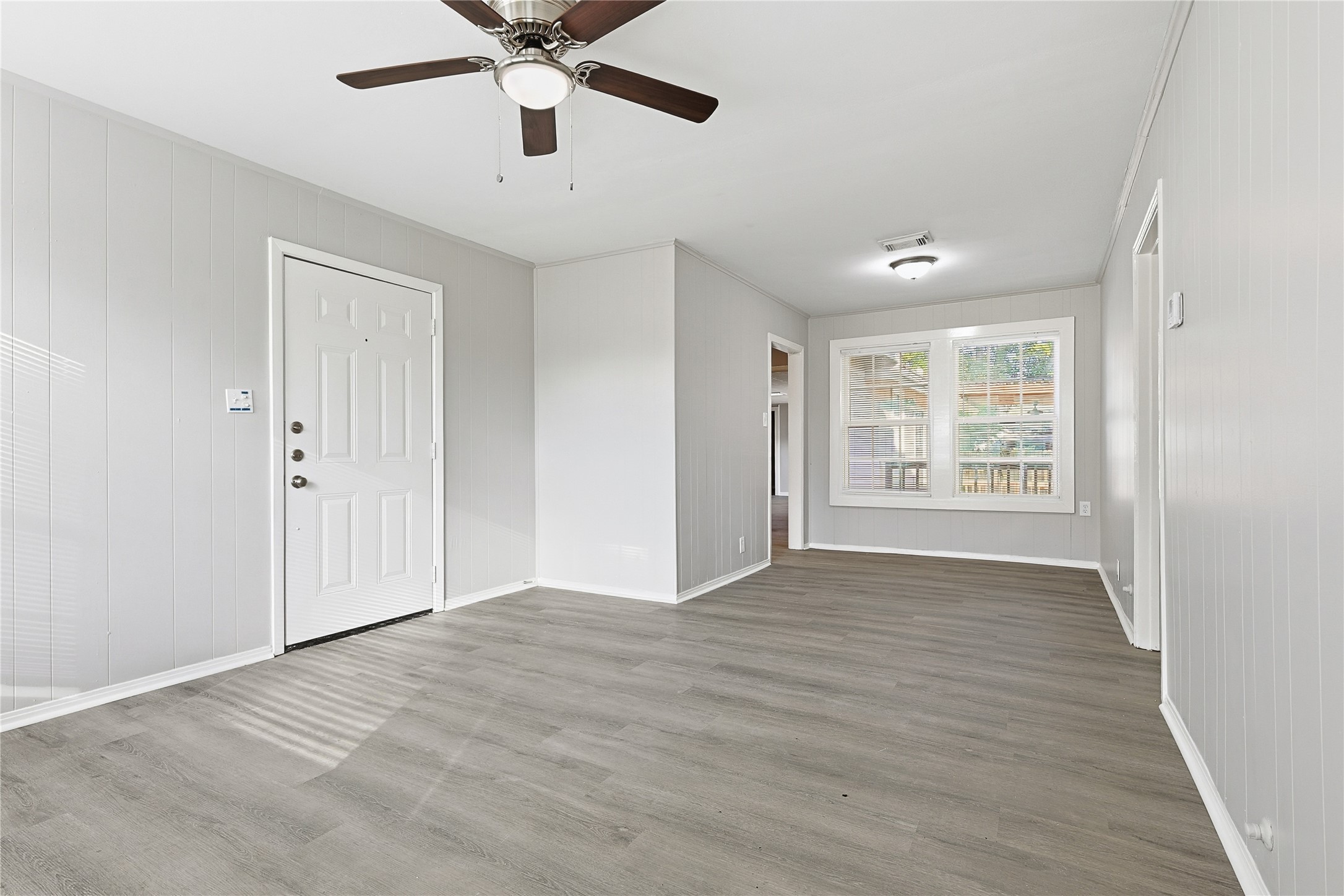 207 Farrer Street Angleton, TX 77515 - Photo 12 of 24 wooden floor in an empty room with a window