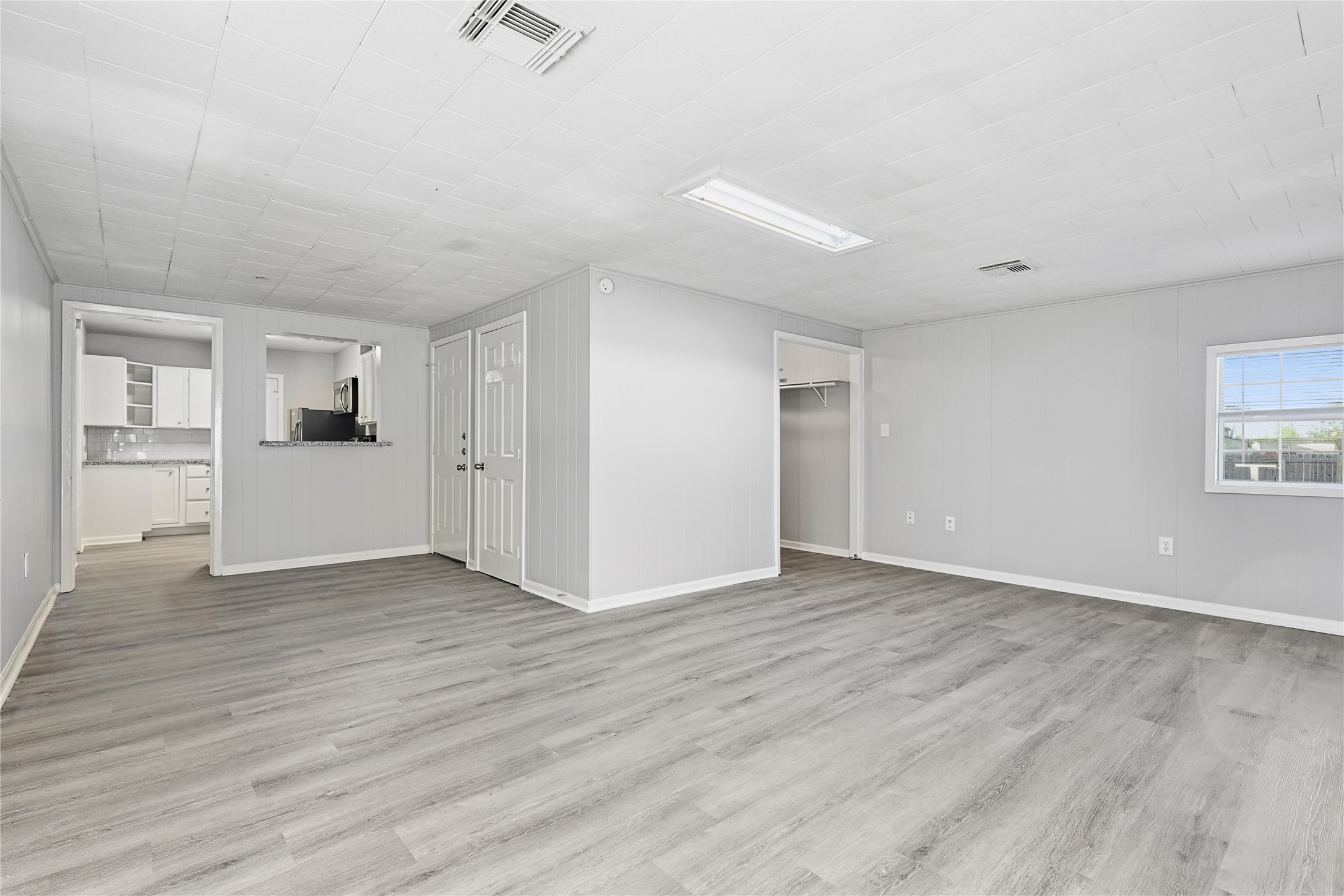 207 Farrer Street Angleton, TX 77515 - Photo 13 of 24 an empty room with wooden floor and windows