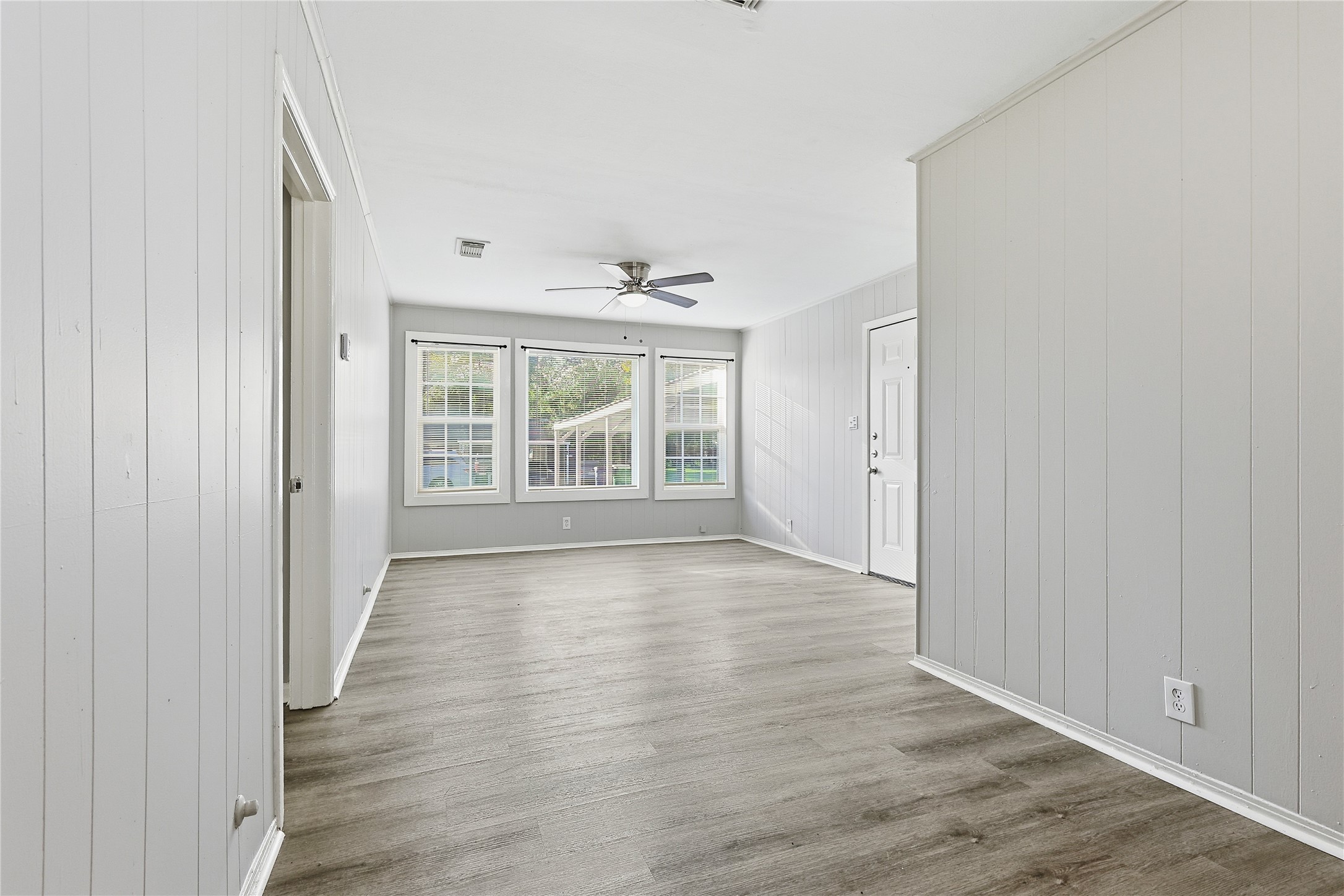 207 Farrer Street Angleton, TX 77515 - Photo 14 of 24 wooden floor in an empty room with a window