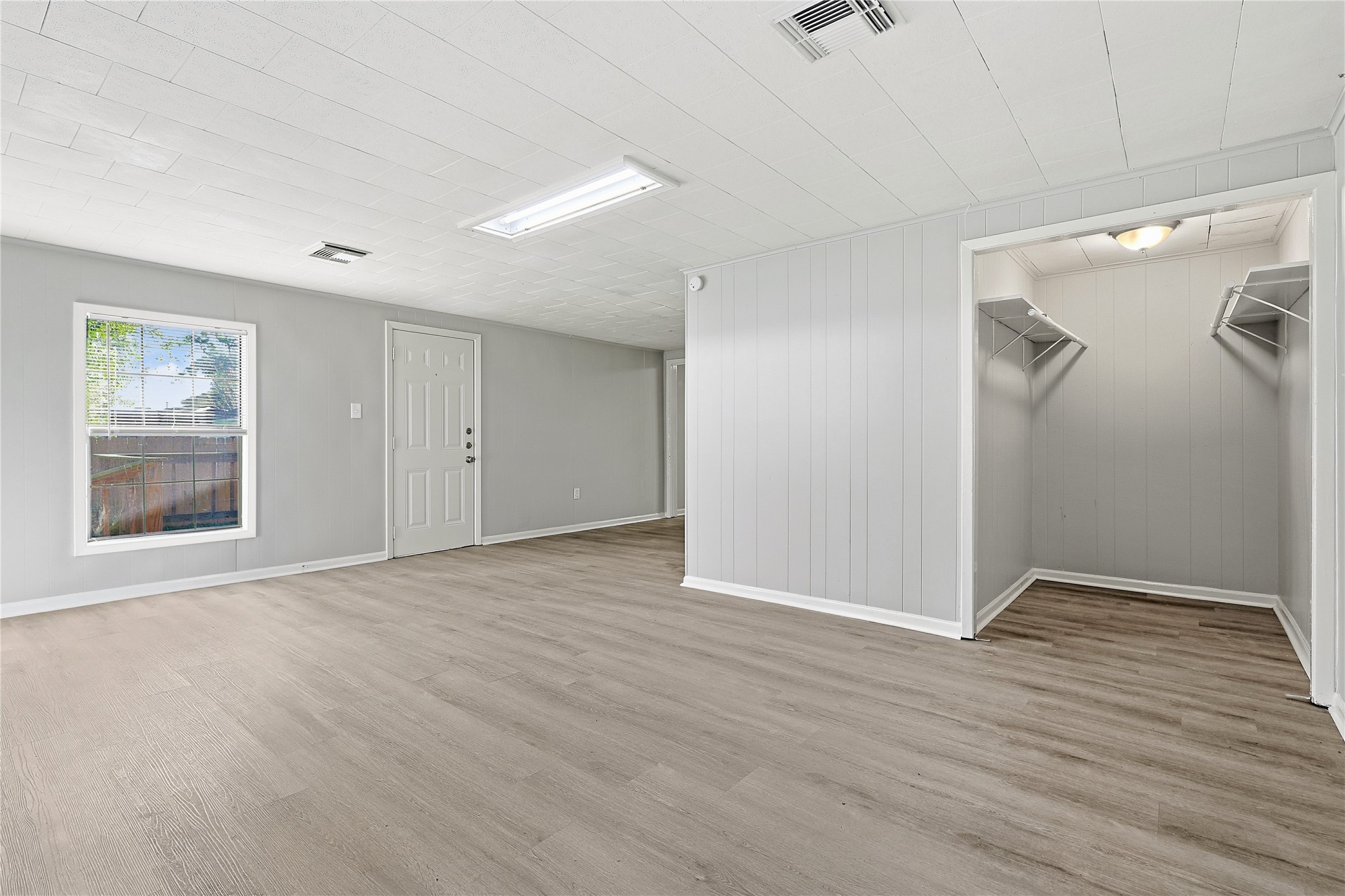 207 Farrer Street Angleton, TX 77515 - Photo 15 of 24 a view of an empty room with wooden floor and a window