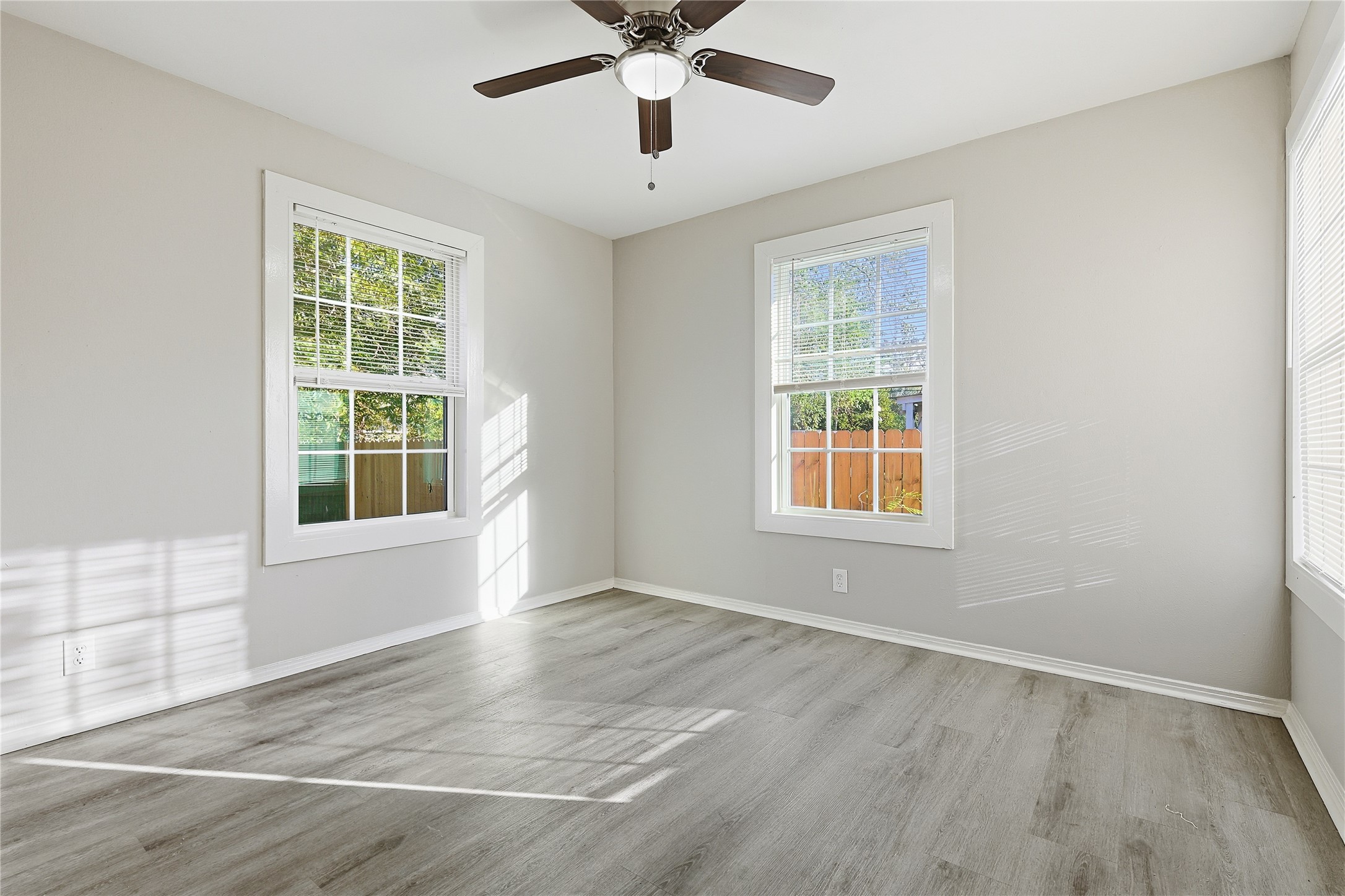 207 Farrer Street Angleton, TX 77515 - Photo 18 of 24 a view of an empty room with wooden floor and a window