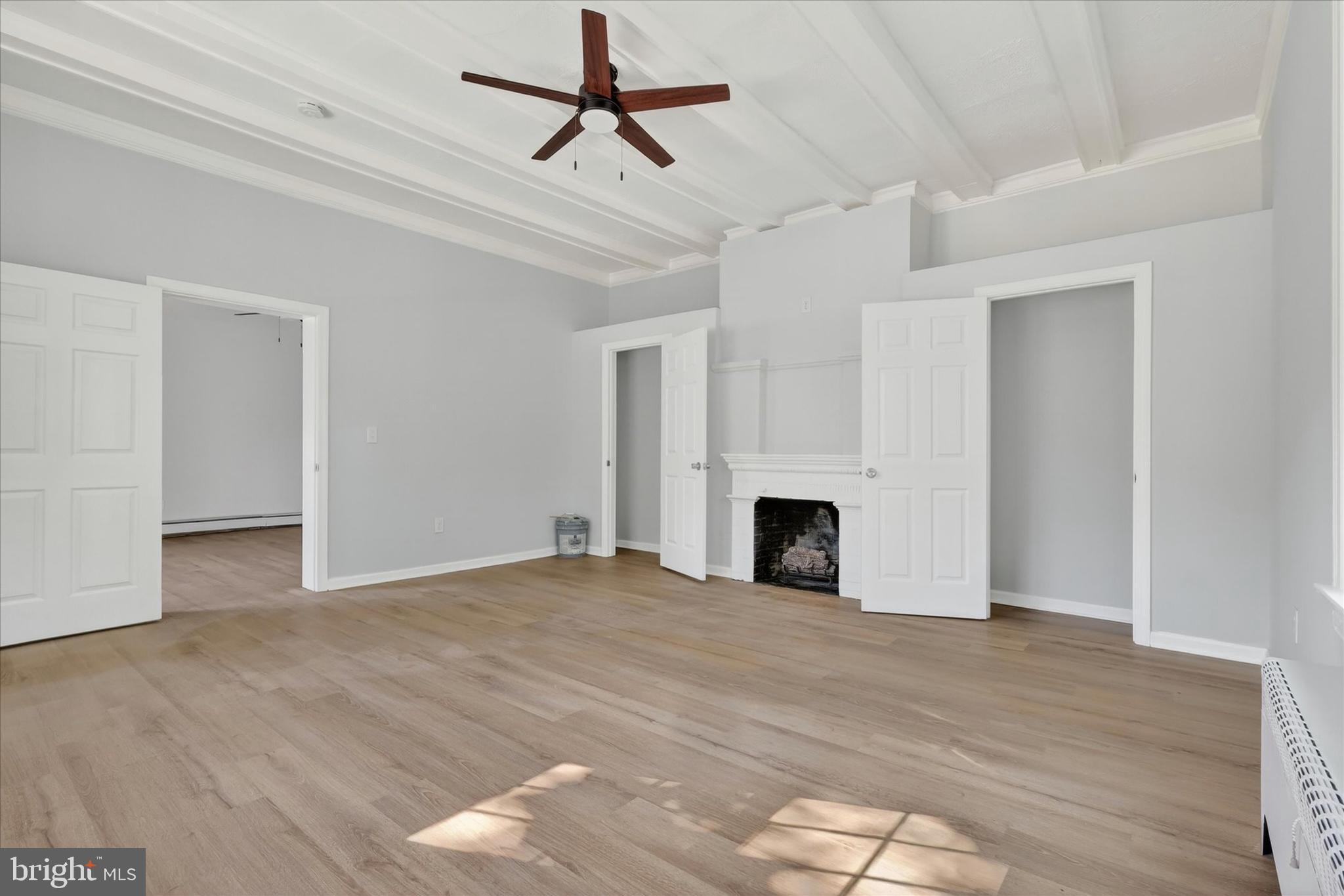 509 Lumberton Road, Unit 1 Hainesport, NJ 08036 - Photo 10 of 33 a view of empty room with wooden floor and fireplace