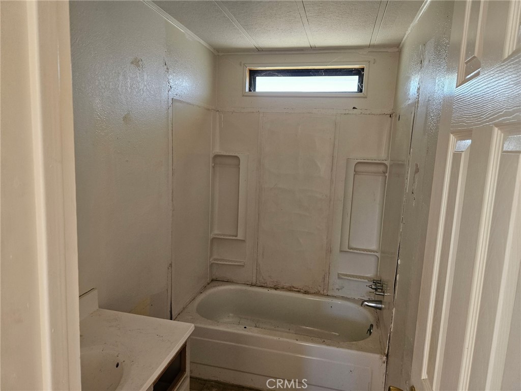 16685 Tehama Dam Road Cottonwood, CA 96022 - Photo 6 of 19 a bathroom with a tub and shower