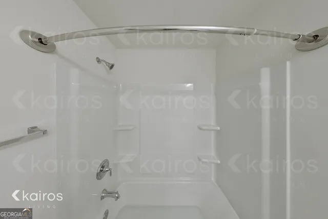 a bathroom with a shower and a bath tub