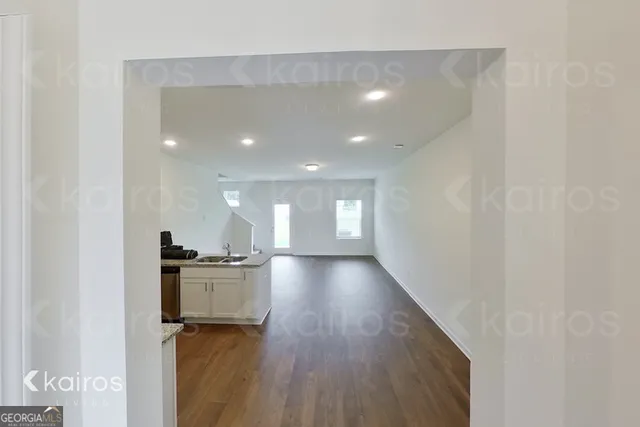 a view of hallway with wooden floor