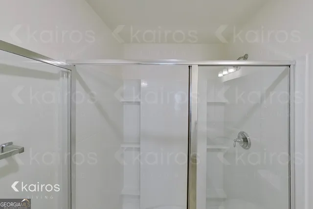 a bathroom with a glass shower door