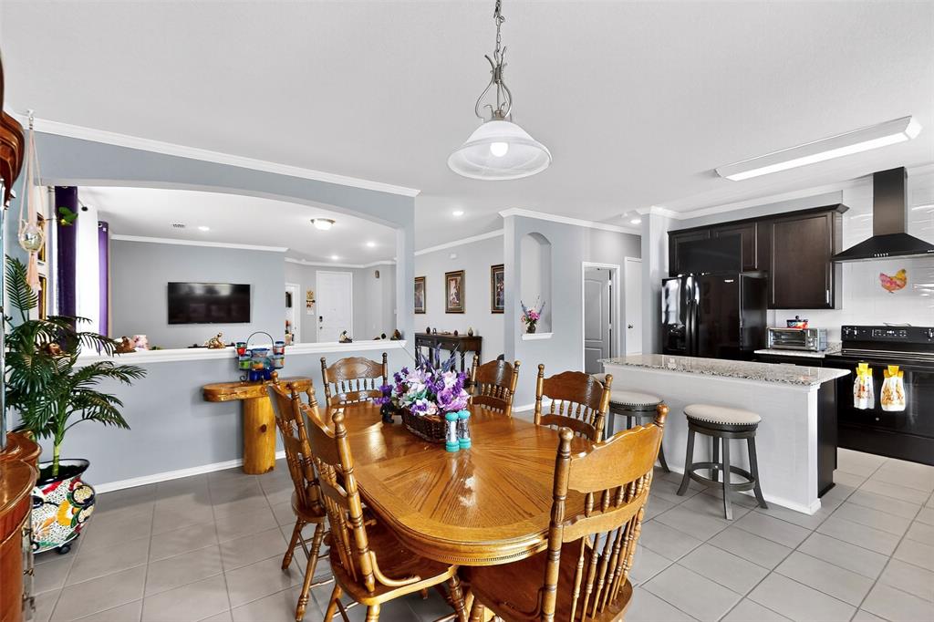 1712 Intervale Road Providence Village, TX 76227 - Photo 11 of 39 a view of a dining room with furniture and a chandelier