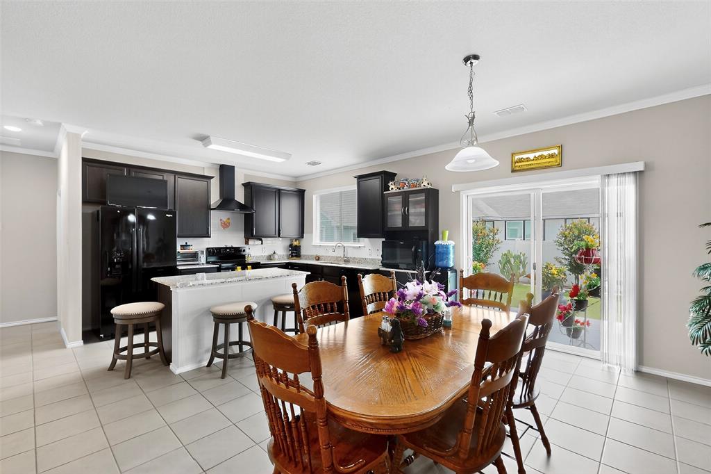 1712 Intervale Road Providence Village, TX 76227 - Photo 12 of 39 a view of a dining room and livingroom with furniture wooden floor a chandelier