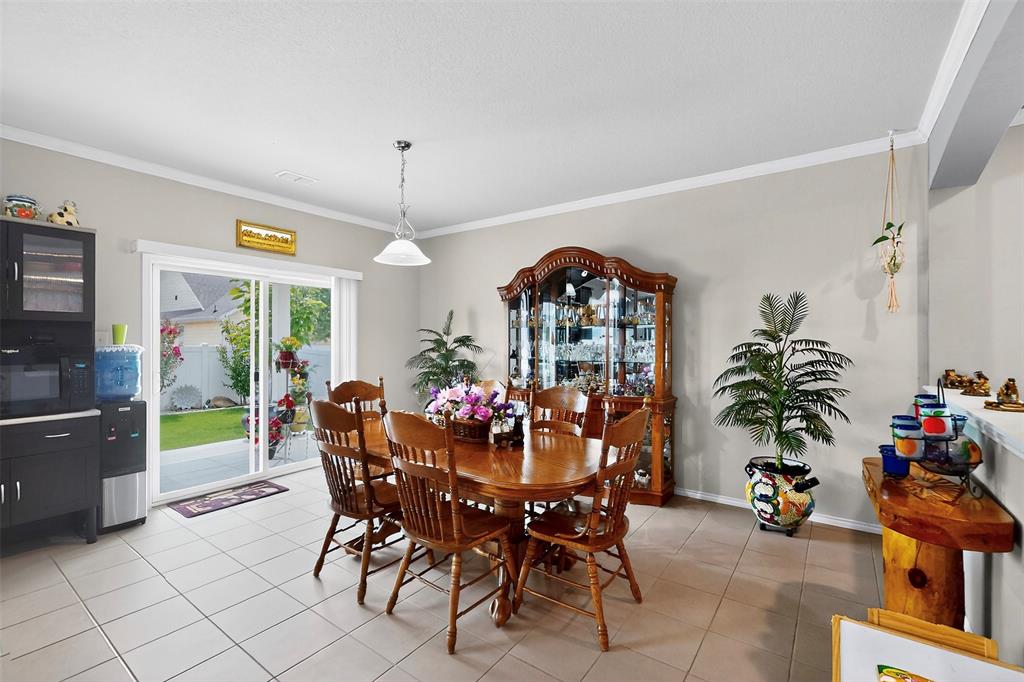 1712 Intervale Road Providence Village, TX 76227 - Photo 13 of 39 a view of a dining room with furniture and chandelier