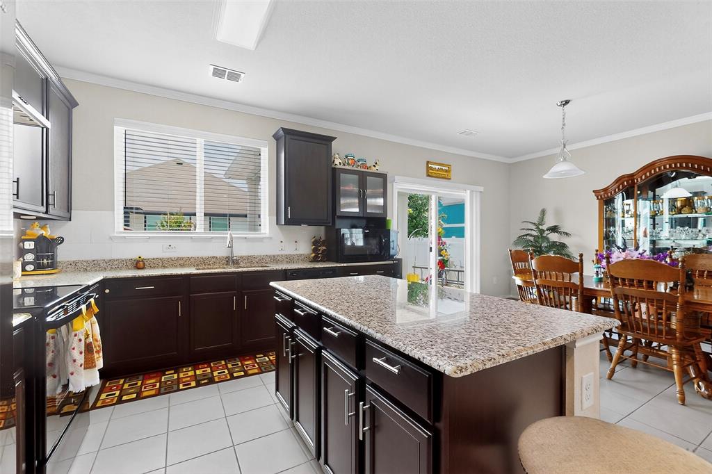 1712 Intervale Road Providence Village, TX 76227 - Photo 16 of 39 a kitchen with a stove a sink dishwasher and a refrigerator