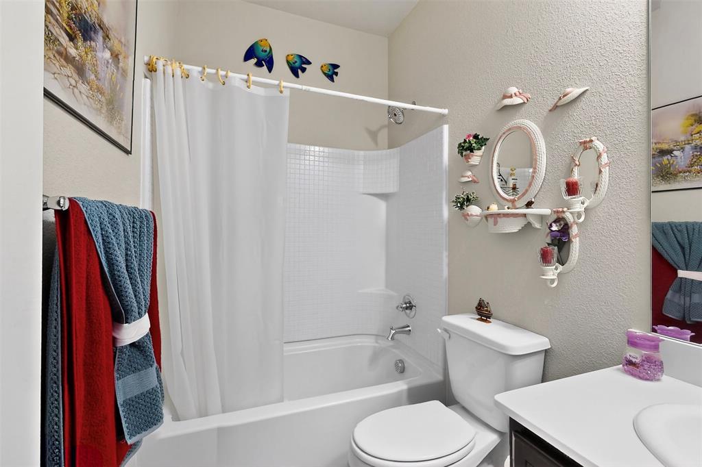 1712 Intervale Road Providence Village, TX 76227 - Photo 21 of 39 a white toilet sitting next to a bath tub and a shower