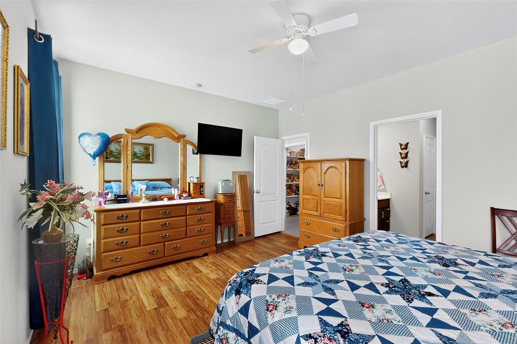 1712 Intervale Road Providence Village, TX 76227 - Photo 24 of 39 a bedroom with a bed and a flat screen tv