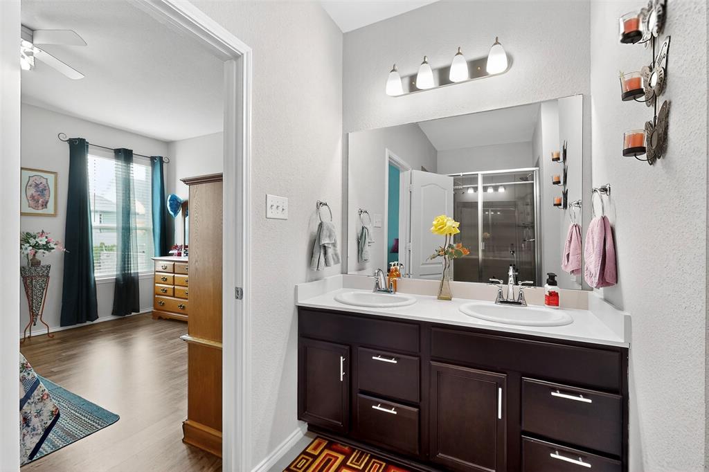 1712 Intervale Road Providence Village, TX 76227 - Photo 25 of 39 a bathroom with a sink vanity granite tub and a mirror