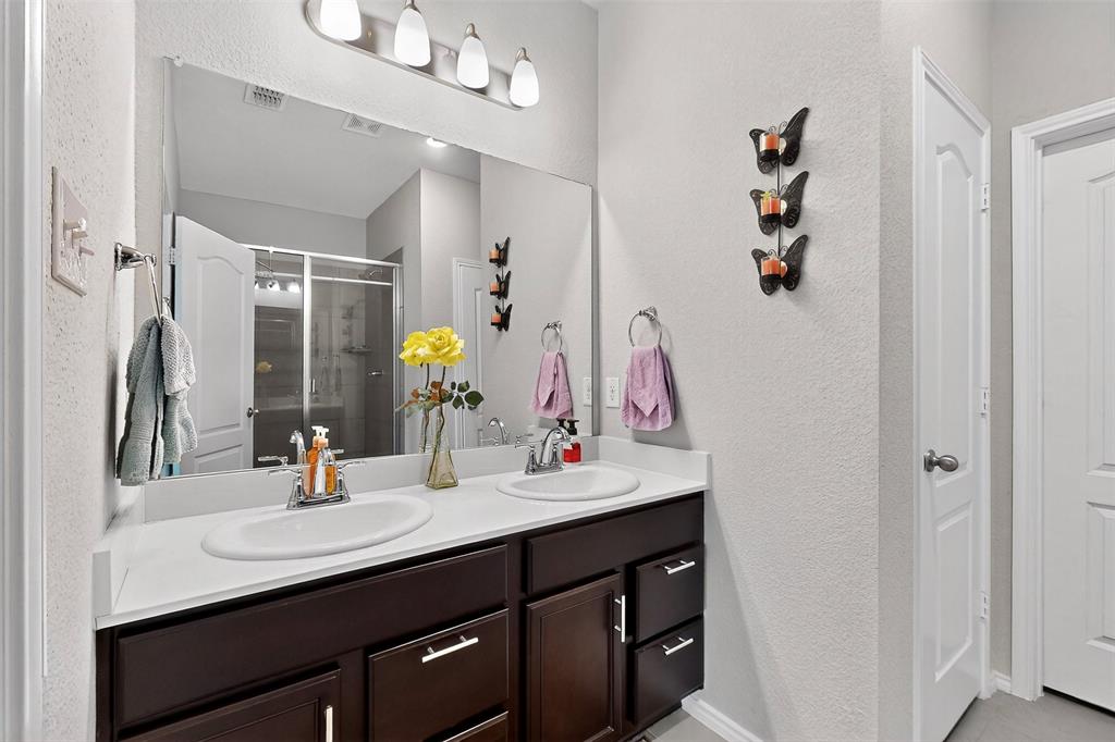 1712 Intervale Road Providence Village, TX 76227 - Photo 26 of 39 a bathroom with a sink vanity and mirror