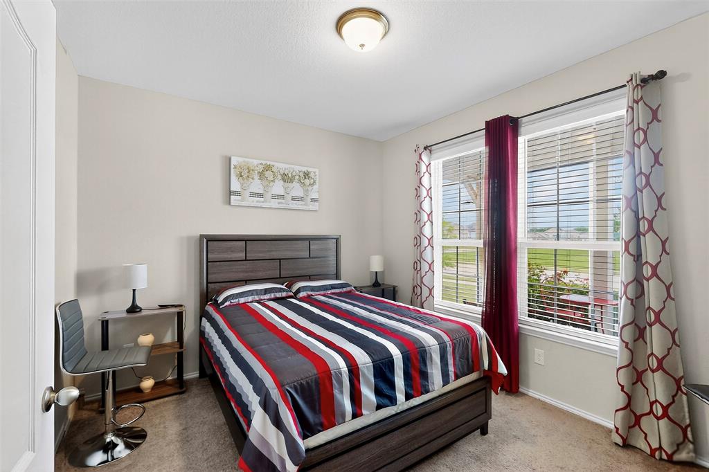 1712 Intervale Road Providence Village, TX 76227 - Photo 30 of 39 a bed sitting in a bedroom next to a window