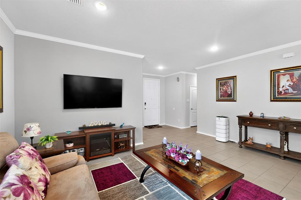 1712 Intervale Road Providence Village, TX 76227 - Photo 8 of 39 a living room with furniture and a flat screen tv
