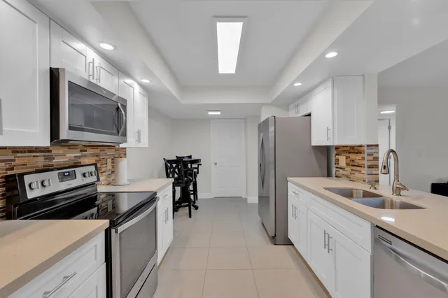 a kitchen with stainless steel appliances a stove sink microwave and cabinets