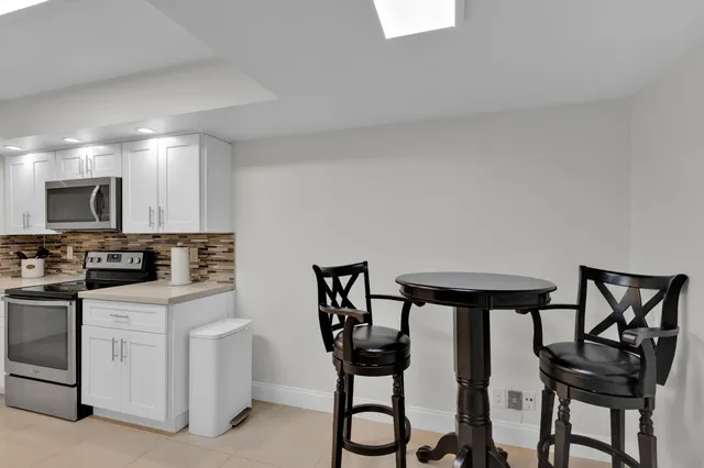 a kitchen with cabinets and chairs