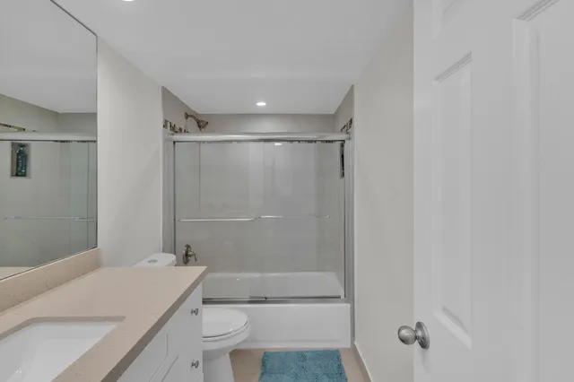 a bathroom with a shower a toilet and a sink