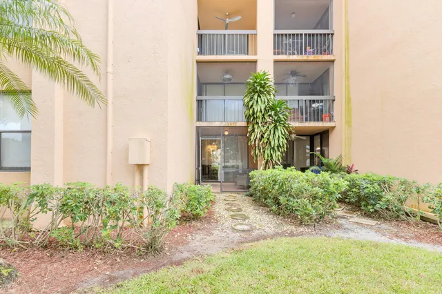 a view of a house with a yard and plants