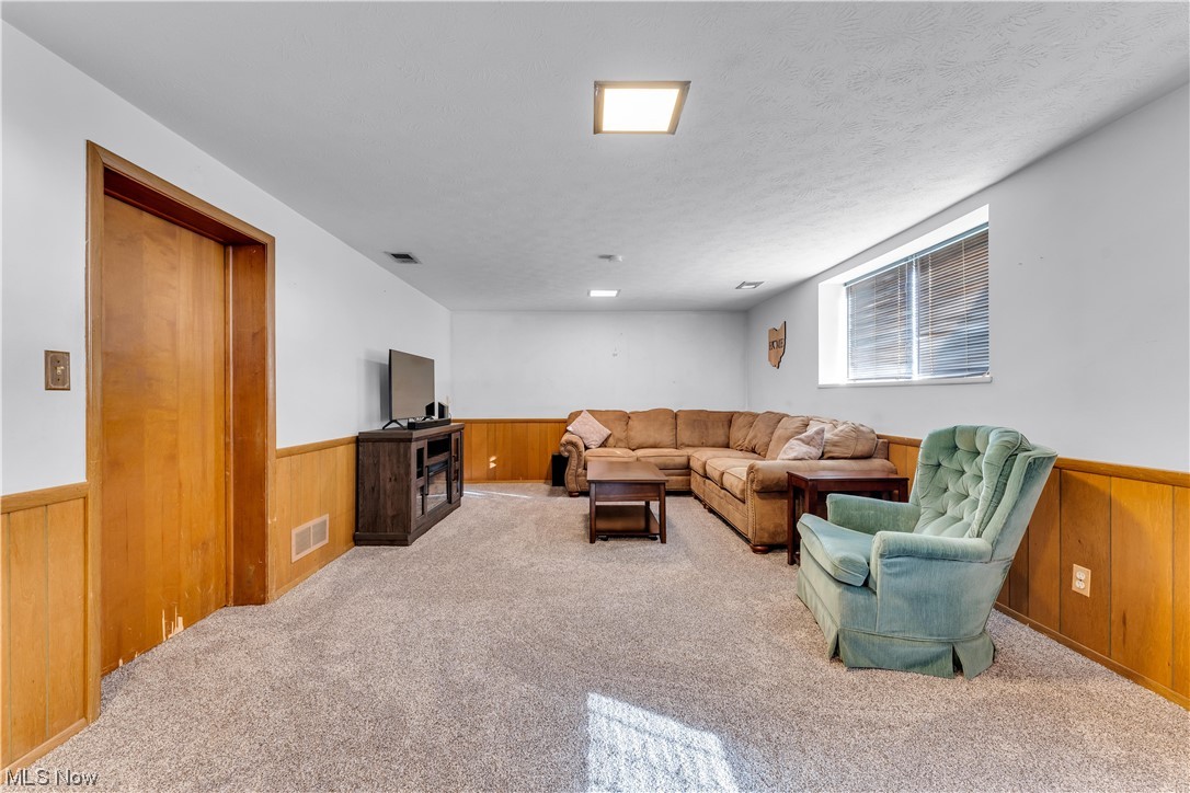 12011 Reno Drive Parma, OH 44130 - Photo 27 of 35 Living room featuring a textured ceiling and light carpet