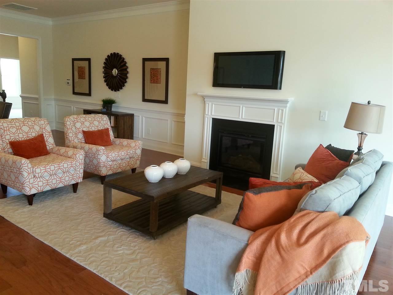 7540 Channery Way Raleigh, NC 27616 - Photo 8 of 25 a living room with furniture and a fireplace