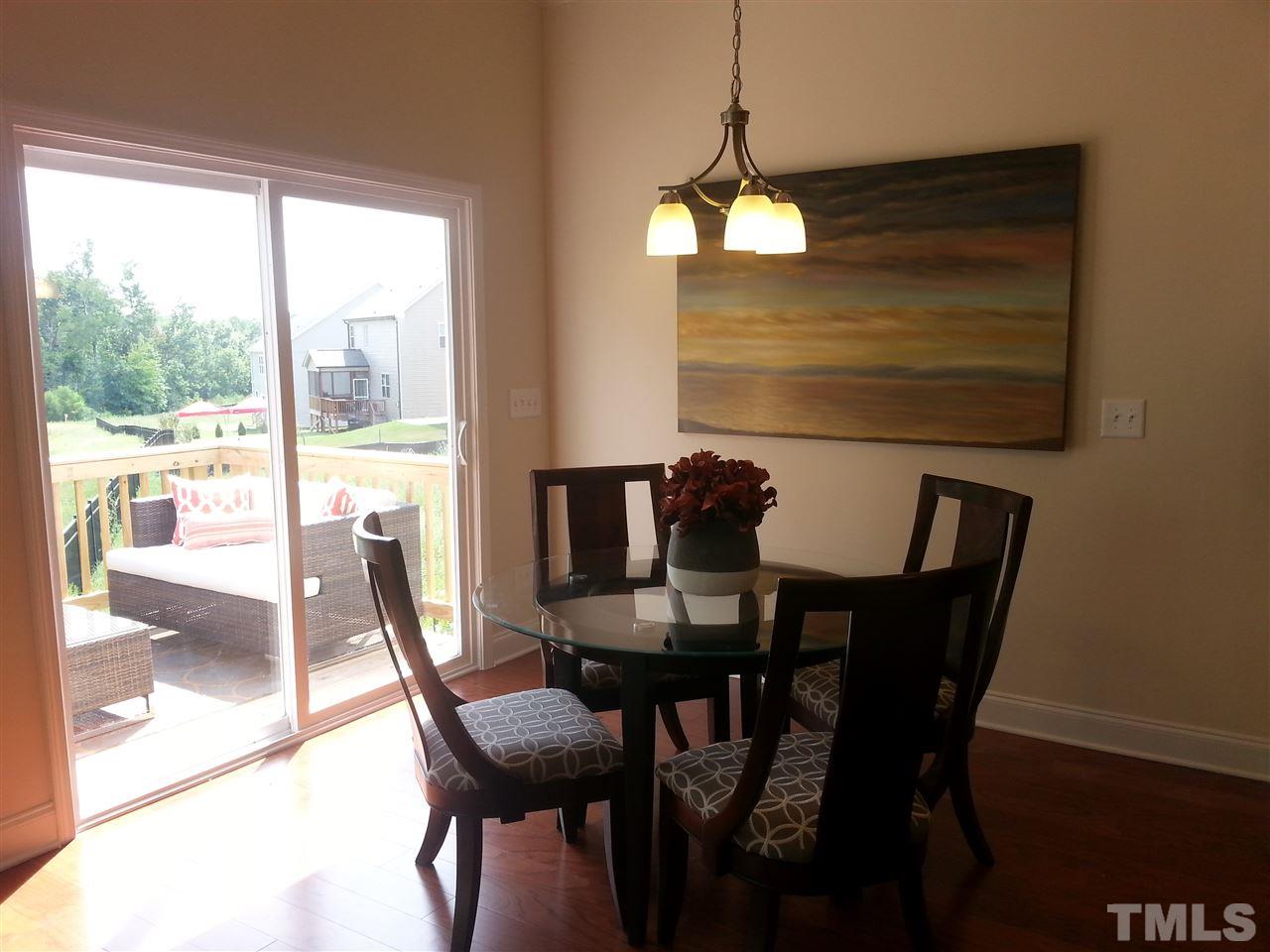 7540 Channery Way Raleigh, NC 27616 - Photo 9 of 25 a view of a dining room with furniture wooden floor and chandelier