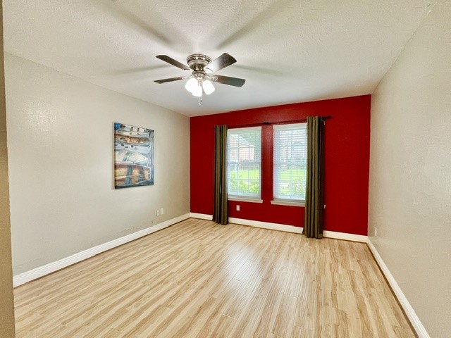 13506 Spring Court Tomball, TX 77375 - Photo 30 of 37 a view of empty room with wooden floor and fan