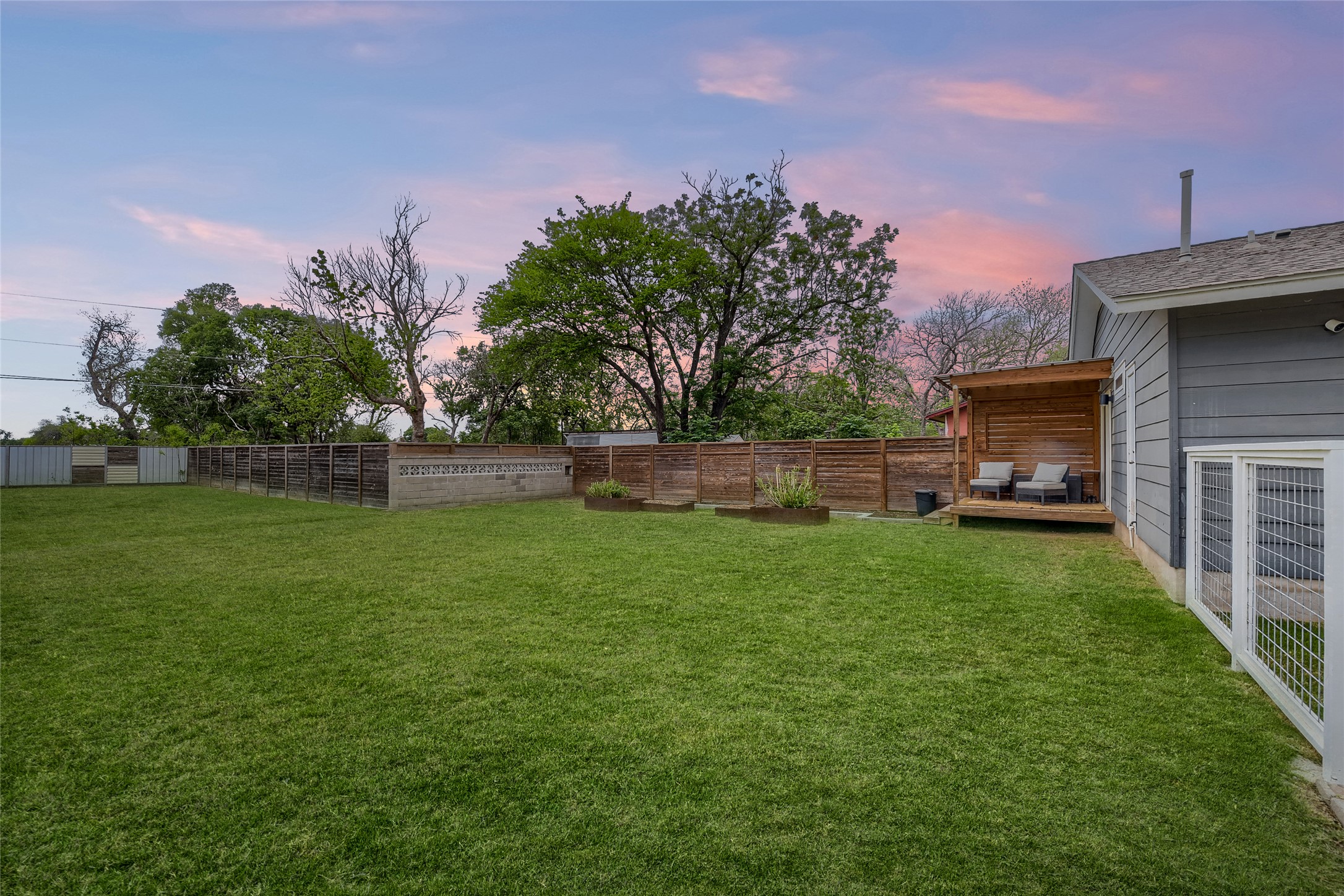 5707 Tracy Lynn Lane, Unit A Austin, TX 78721 - Photo 26 of 33 Yard at dusk with a deck and a fenced backyard