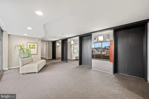 a view of a livingroom with furniture and an entryway