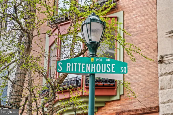 a street sign on a brick wall