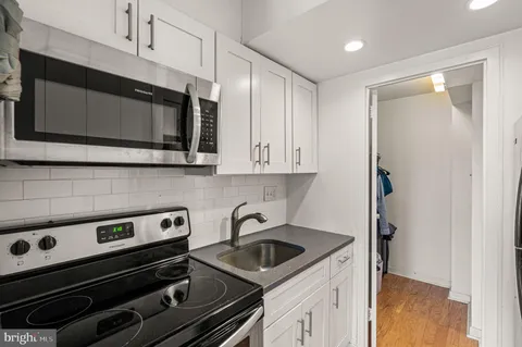 a kitchen with a stove and a microwave