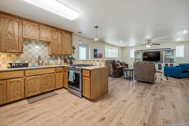 a kitchen with stove a sink and a microwave
