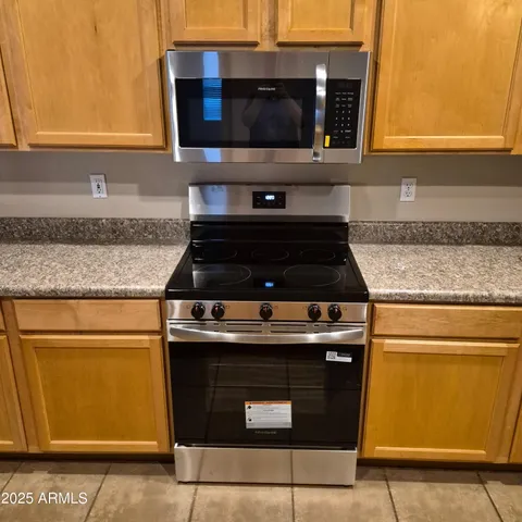 a kitchen with granite countertop cabinets and steel stainless steel appliances