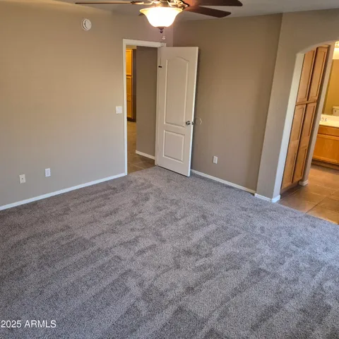 an empty room with closet and mirror