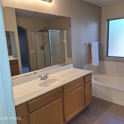a bathroom with a tub sink and mirror