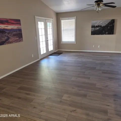 wooden floor in an empty room with a window