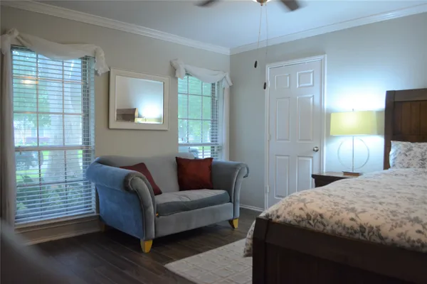 a bedroom with a bed and a couch