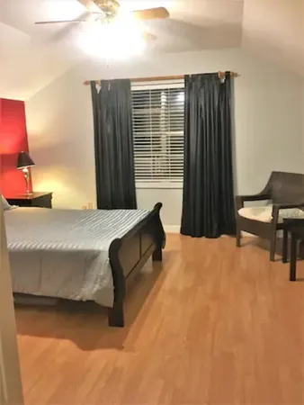 a bedroom with a bed and chair