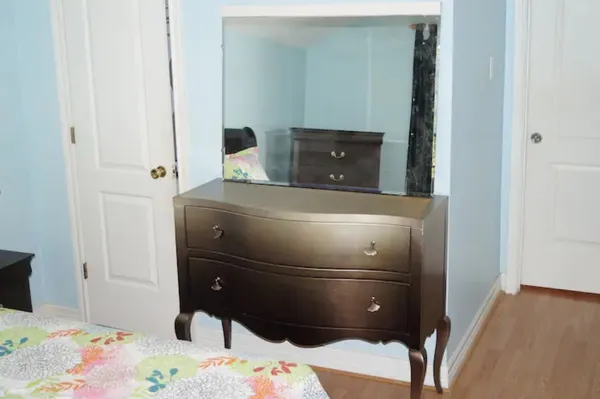 a bedroom with a bed and a dresser