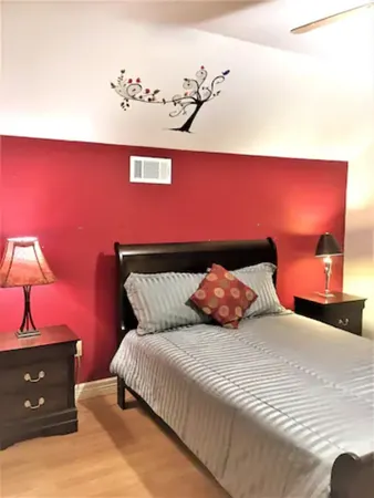 a bedroom with a bed and a lamp with window