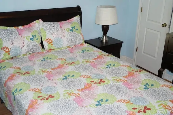a bedroom with a bed and a lamp