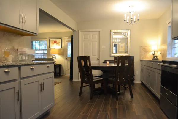 a view of a dining room with furniture and wooden floor