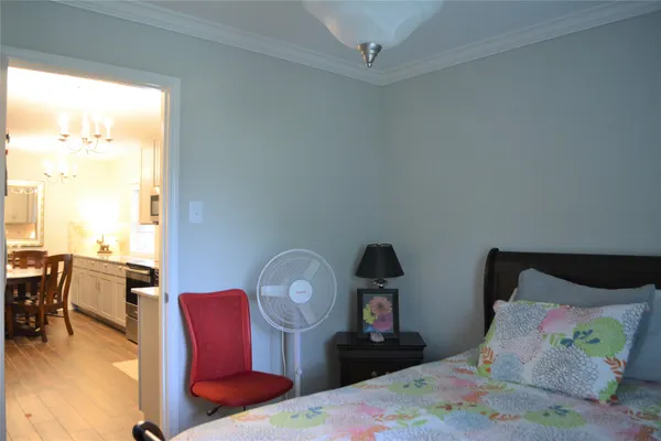 a bedroom with furniture and a large window